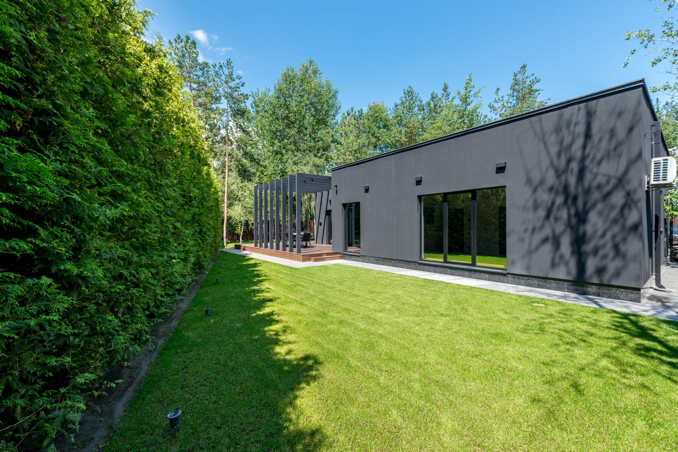 Moderne woning met grote ramen en donkere kozijnen